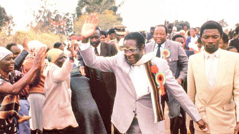 Zimbabwe’s Robert Mugabe waves, attends an election rally near Harare, in July 1985. His Zanu Party won a landslide victory in the country’s first election since independence 