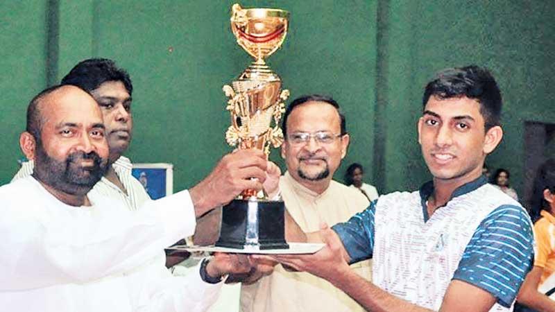 Richmond skipper Chamath Dias receiving the Super ‘A’ division champion’s trophy from Sabaragamauwa Province Badminton Association president Ranjith Siyambalapitiya
