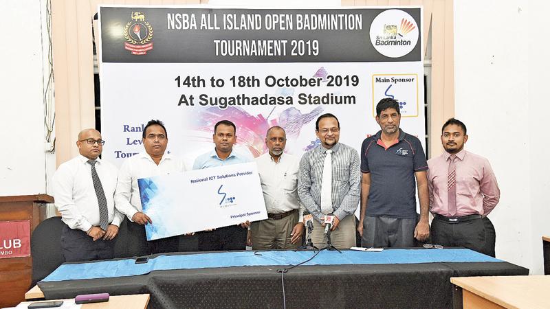 Sri Lanka Telecom Corporate Relations General Manager Rohan Ellawala (left) presenting the sponsorship cheque to Nationalised Services Badminton Association Secretary Upul Gamlath in the presence of Sri Lanka Badminton (SLB) President Rohan de Silva