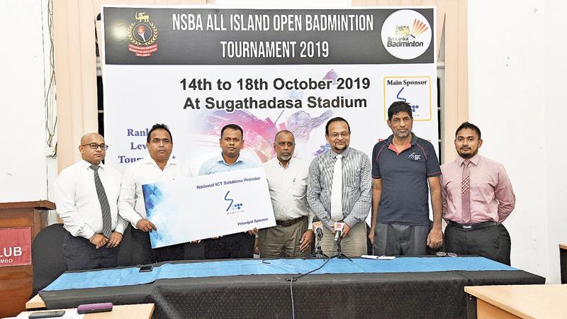 Sri Lanka Telecom Corporate Relations General Manager Rohan Ellawala (left) presenting the sponsorship cheque to Nationalised Services Badminton Association Secretary Upul Gamlath in the presence of Sri Lanka Badminton (SLB) President Rohan de Silva  