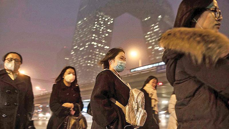 Chinese women wearing masks to protect against pollution in Beijing in 2015. The government has made inroads against China’s pollution problem.     