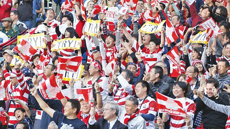 Japanese rugby fans at the World Cup cheer their team