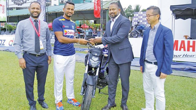 Sri Lanka captain Dimuth Karunaratne receives the motorcycle.