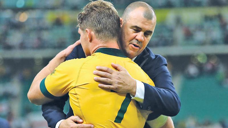 Michael Hooper and Michael Cheika react after Australia’s quarter final defeat at the World Cup