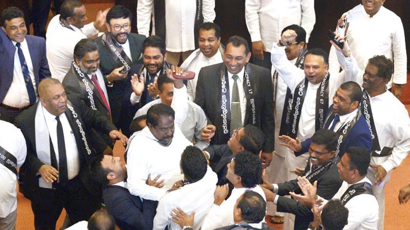 Members of the Sri Lankan parliament shout slogans in support of then ousted prime minister Ranil Wickremesinghe during a parliament session on November 14, 2018. Pic courtesy Lakruwan Wanniarachchi/AFP