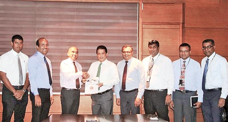 CEO, DFCC Lakshman Silva (fourth from left) and Managing Director LIOC, Manoj Gupta exchange the agreement. Looking on (from left) are Manager, Sales, LIOC,  Surien Gomez, SVP Retail, LIOC, Girish Rajan, Chief Operating Officer, DFCC, Achintha Hewanayake, Head of IT, DFCC, Nishan Weerasooriya, Vice President, Services and Procurement, DFCC, Gaminda Fernando and Assistant Vice President Digital Strategy, DFCC, Dinesh Jebamani.