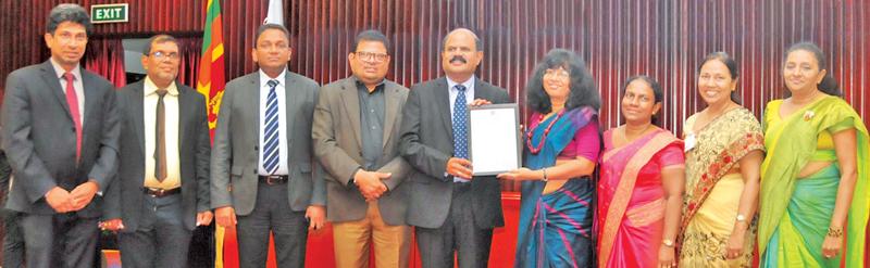 SLT Group Chairman, P.G. Kumarasinghe Sirisena receives the certificate from Director General of SLSI, Dr. Siddhika Senaratne, on behalf of SLT at a ceremony at the BMICH recently.   