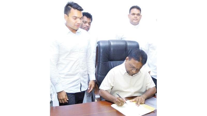 Newly appointed Sports Minister Dallas Alahapperuma assumes duties as former Sri Lanka rugby captain and MP Namal Rajapaksa (left) and MP Shehan Semasinghe (right) grace the occasion  
