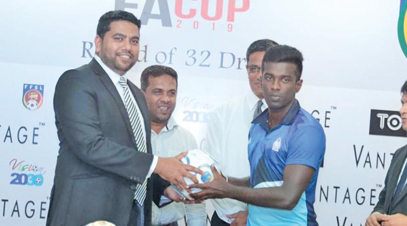 Marketing Manager of Ebony Holdings Mohamed Musfir presenting a ball to the Police SC captain. Also in the is Anura de Silve President of FFSL.  Pic by Shan Rambukwella.  