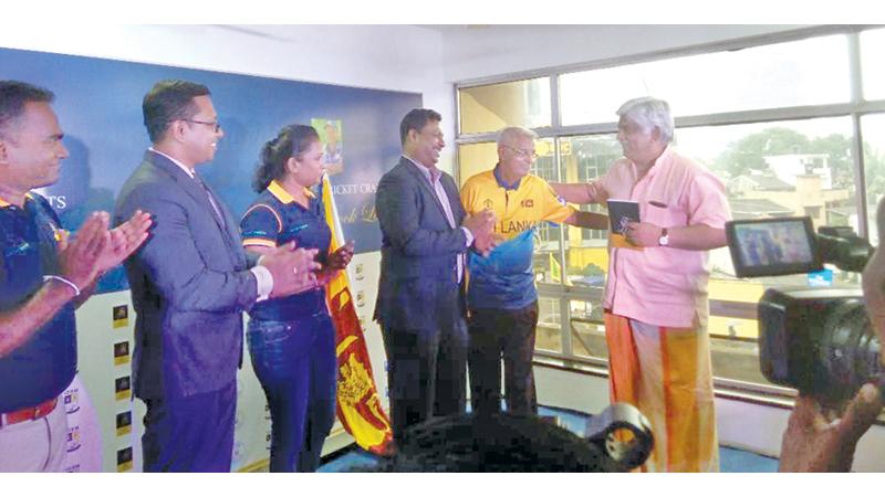 Percy Abeysekera presents his book to Arjuna Ranatunga in the presence of Chance Sports chairman Lasantha Amarasinghe