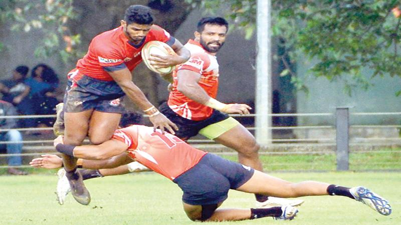 CR’s forward Janidu Fernando is airborne in the face of a tackle from the CH defence in their Dialog League rugby match at the Race Course ground in Colombo yesterday (Pic Saman Mendis)  
