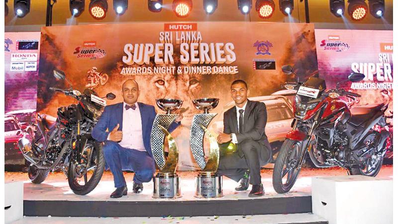 Hutch Super Series winners driver Ashan Silva and rider Jacques Goonawardena pose for a picture after receiving their awards and a Honda 250cc motorcycle each from Stafford Motors