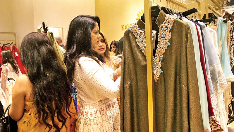 Set aside specific days and budgets for shopping, travelling, visiting friends and other activities. This will help prevent the last-minute scramble to buy gifts. Here guests at the opening of a clothing store. Pic: Chaminda Niroshana