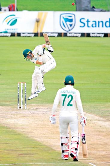 South Africa’s Anrich Nortje reacts after being hit by a ball delivered by England’s Stuart Broad as South Africa’s Rassie van der Dussen (R) looks on during the third day of the first Test cricket match between South Africa and England at The SuperSport Park stadium at Centurion near Pretoria on December 28, 2019. (AFP)