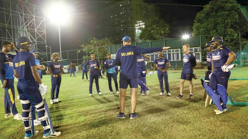 Sri Lanka’s cricketers listen to their coach Mickey Arthur at a field team meeting ahead of today’s first T20 International in Guwahati, India  