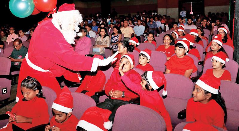 Santa entertains children.   