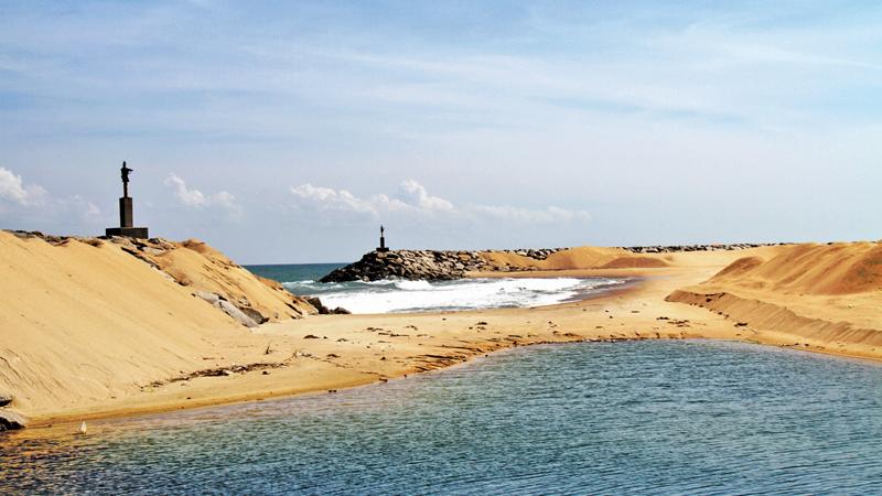 The sand dunes at the mouth of the harbour