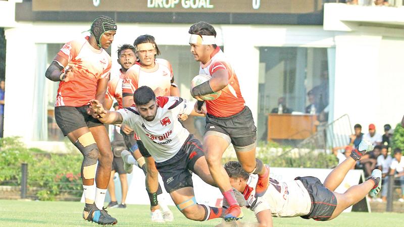 CH and FC scrum half Avishka Lee faces opposition from Kandy SC centre Tarinda Ratwatte as his team mate Samuel Maduwantha joins in for  support (Pic by Shan Rambukwella)    