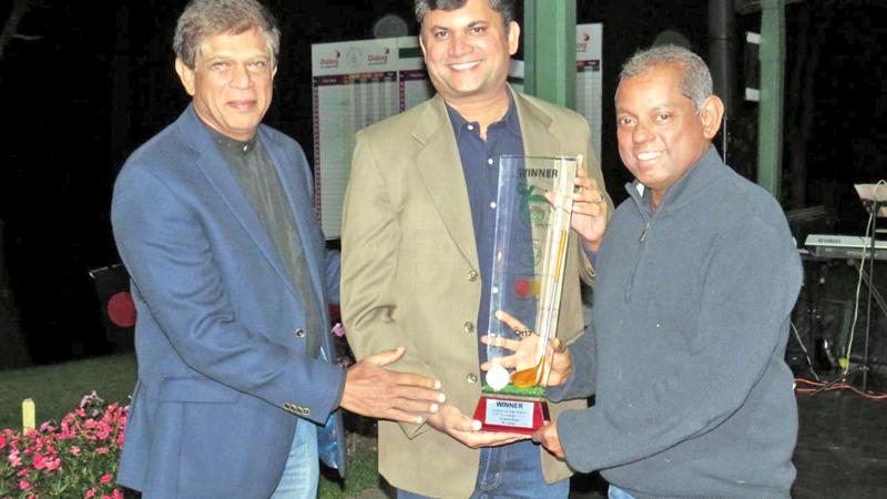 Priyanga Hapugalle the captain of the Invitational Sri Lanka team receiving the NEGC Mastercard Trophy from Santosh Kumar, Country Manager, Mastercard, Sri Lanka & Maldives and Maj Gen Srinath Rajapakse, President NEGC    