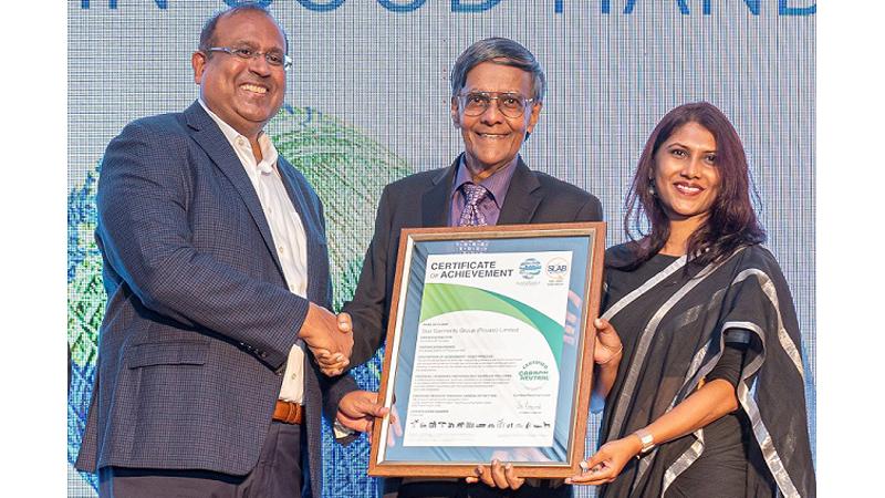 Managing Director, Star Garment Group, A. Sukumaran receives the certification from   Chairman, Carbon Consulting Company, Prof. Mohan Munasinghe and Head of  Sustainability and Advisory Service, The Sustainable Future Group, Dr. Lakmini Senadheera. 