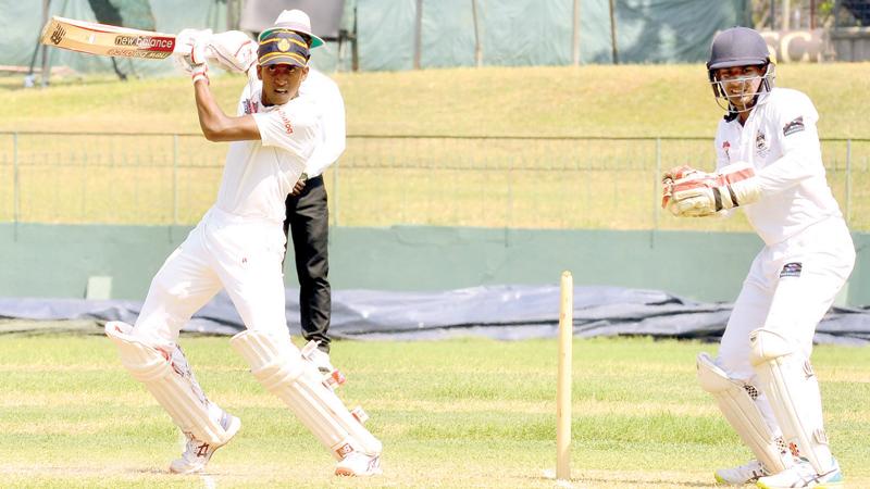 Royal College batsman Isiwara Dissanayake cuts a ball on his way to a century during the second day’s play of their inter school match against St. Peter’s College at the SSC ground in Colombo yesterday (Pic by Saman Mendis)