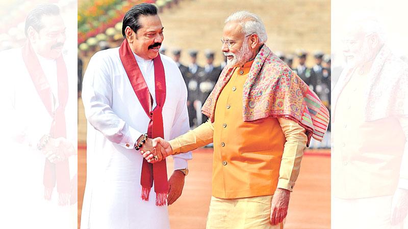 India’s Prime Minister Narendra Modi shakes hands with Sri Lanka’s Prime Minister Mahinda Rajapaksa during a ceremonial reception at the Presidential palace in New Delhi yesterday. Prime Minister Rajapaksa is due to conclude his four-day state visit to India tomorrow. – AFP