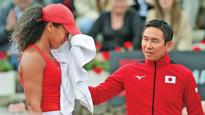 Naomi Osaka (left) takes a break