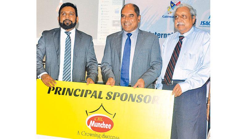 Main sponsor Ceylon Biscuits Managing Director S. Wickramasinghe (left) and principal sponsor Edexcel Territory Manager for Sri Lanka, Maldives, Pakistan and Nepal, Suriya Bibile (right) presenting the sponsorship to Gateway Group Chairman Harsha Alles. Picture by Ranjith Asanka 