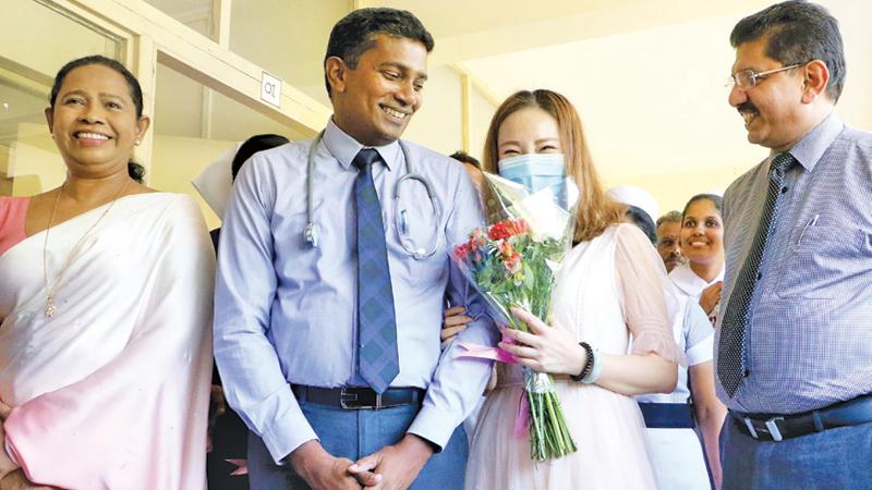 The Chinese national with doctors and Health Minister Pavithra Wanniarachchi. Pix: Saman Sri Wedage
