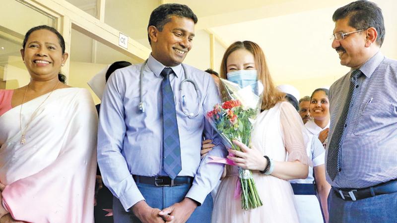 The Chinese national with doctors and Health Minister Pavithra Wanniarachchi.                                                         Pix: Saman Sri Wedage