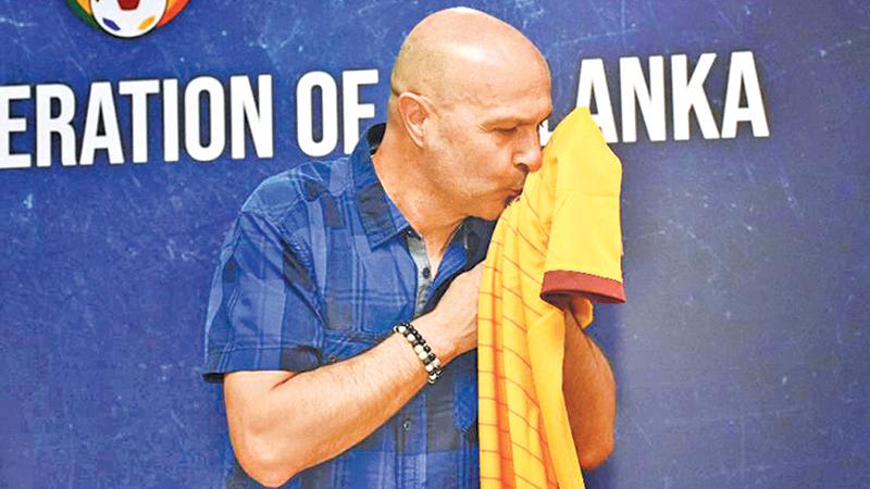 New Sri Lanka football coach Amir Alagic kisses the team’s new jersey     