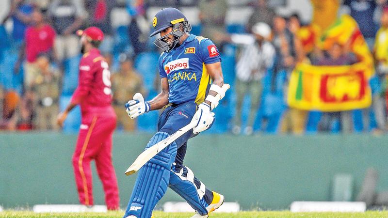 Wanindu Hasaranga celebrates after Sri Lanka beat  the West Indies by one wicket at the Sinhalese Sports Club (SSC) ground in Colombo yesterday. (Photo by Ishara S. KODIKARA / AFP)