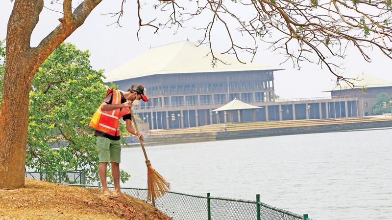 Amid the wide speculation about the dissolution of Sri Lanka’s eighth Parliament this week, a worker of the Municipal Council, Sri Jayewardenepura, Kotte engaged in his daily routine of sprucing up the area yesterday. Unlike the previous elections, there is a growing demand to get rid of misfits and elect a people-friendly, educated 225 upright MPs to the new Legislature in order that the problems of the masses could be resolved.  Pic: Rukmal Gamage.