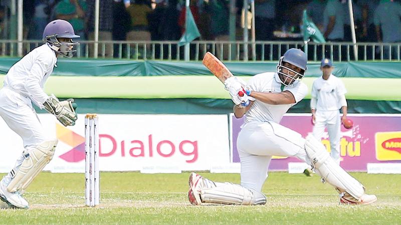 Isipathana batsman Ravindu Ratnayake sweeps a ball to the boundary on his way to a half century during their drawn inter school big match against Thurstan at the SSC ground yesterday. The match ended in a tame draw (Pic by Nissanka de Silva)