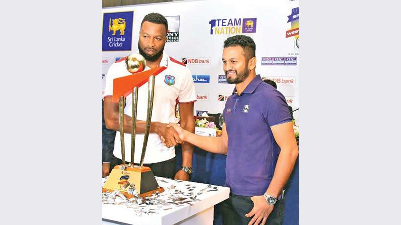The trophy will be with Sri Lanka today as West Indies captain Kieron Pollard (left) and his Sri Lankan counterpart Dimuth Karunaratne hold it at the launch of the series last week (Pic by Sudath Malaweera)
