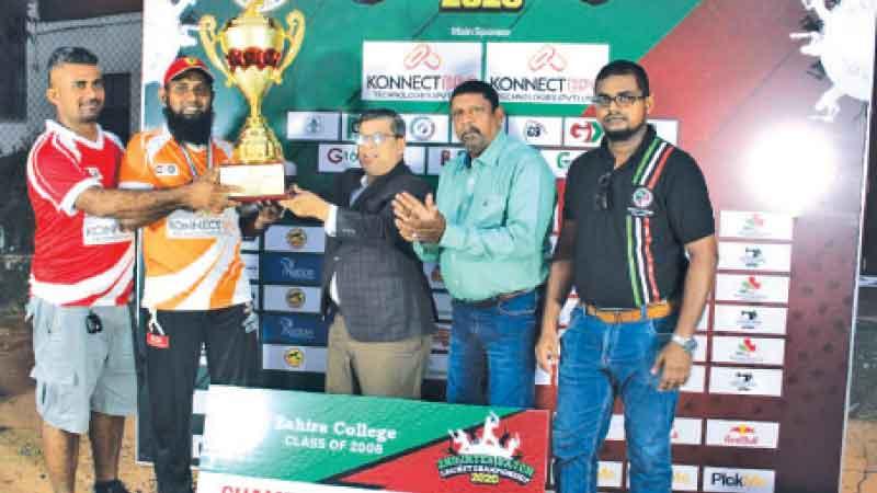 Captain of the G 2003 B Team Mohamed Kaleel receiving the champions trophy from chief guest Alavi Mukthar 