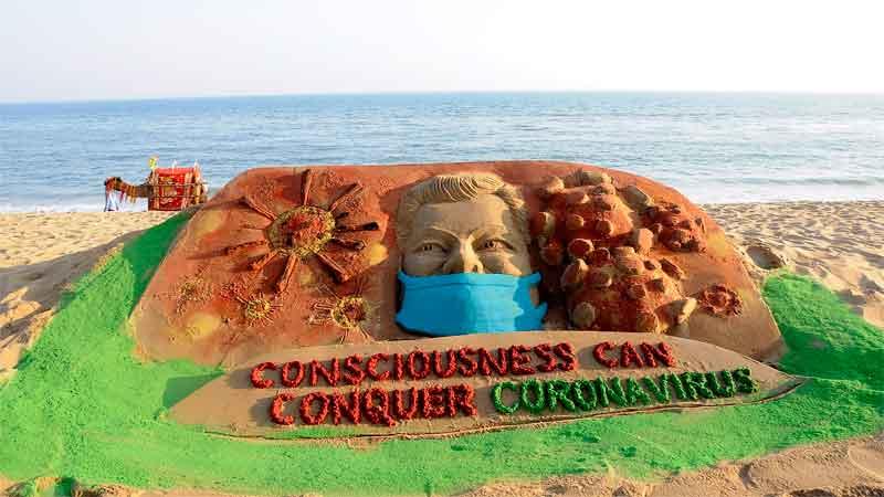 Manas Sahoo : This Indian sand artist based in Puri works with the material of sand on the beach. His piece by the beach reads “Consciousness can conquer Coronavirus.”