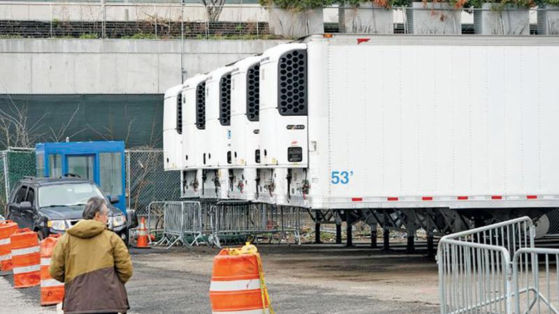 Refrigerated trailers are in place as workers build a makeshift morgue to handle an expected surge in coronavirus victims.