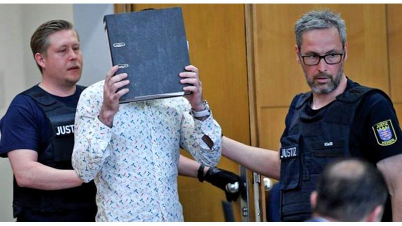 Taha al-J hid his face as he entered the courtroom in Frankfurt (AFP)