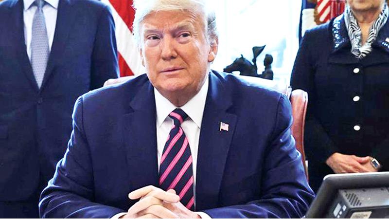 United States President Donald Trump sitting during the signing ceremony of the Paycheck Protection Program and Health Care Enhancement Act, in Washington