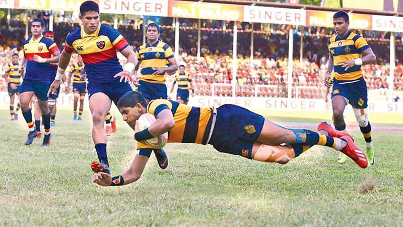 Royal College centre Lehan Gunaratne goes over the line for a try at last year’s Bradby match in this file photo captured by Sulochana Gamage