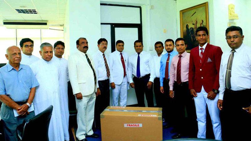 Sri Lanka Cricket president Shammi Silva presenting the first 16 bowling machines to Under-19 division one schools at a simple ceremony held at the SLC headquarters in the presence of Sri Lankan Schools Cricket Association president Thilak Wattuhewa, school principals and masters in charge of school teams