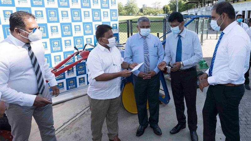Sport Minister Dallas Alahapperuma makes a presentation of Rs 20,000 each made available by Sri Lanka Cricket to school coaches affected by the recent coronavirus lockdown in the presence of SLC President Shammi Silva and Sport Ministry Secretary KDS Ruwanchandra