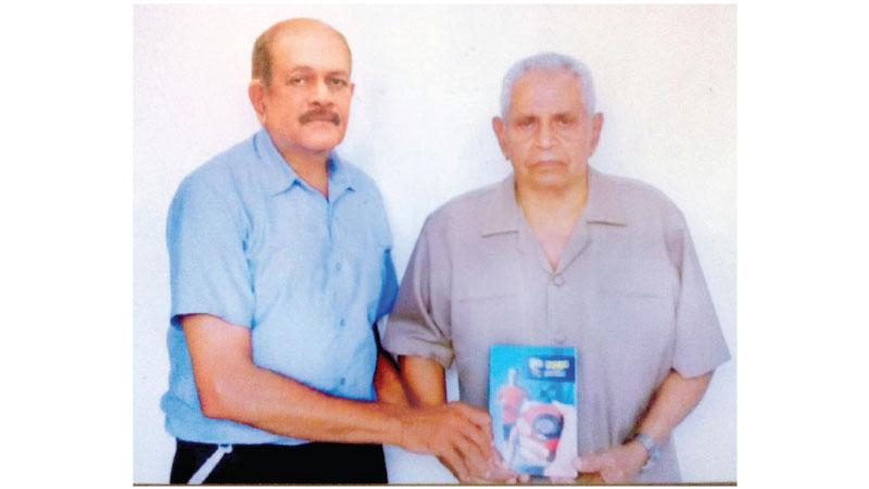Pictured here is Gunawardena (left), presenting the first copy of the book to former National shot put champion and senior athletics coach of the Sports Ministry, AJ Rodrigo (Sr)
