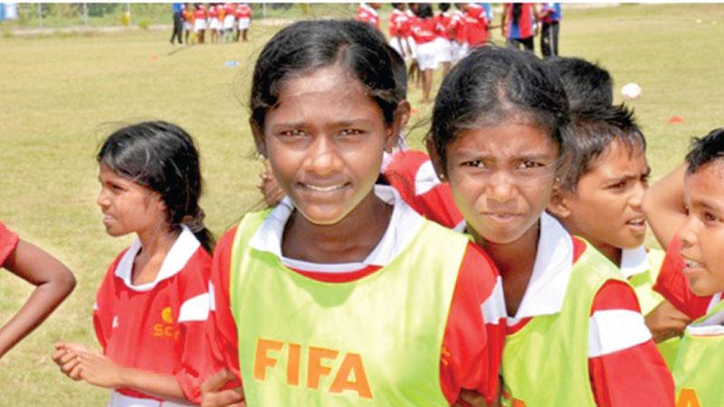 Young girls come together at a football camp