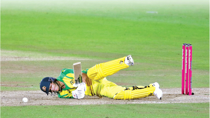 Australia’s batsman David Warner falls to the ground after being hit by the ball (AFP)