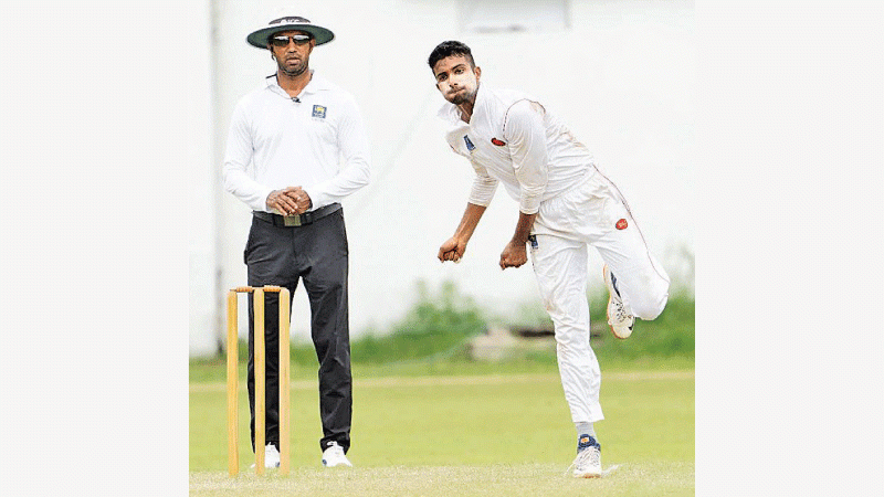 International umpire Kumara Dharmasena watches leading club bowler Duvindu Tillekaratne bowler
