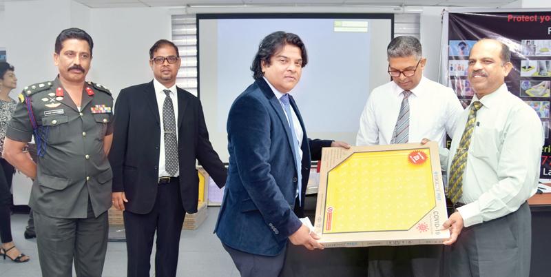 Edgeng Lanka Directors  Shihan Ganegoda and Don Sidantha Ganegoda present the foot sanitising trays to the officials of the Department of Immigration and Emigration, the Department of Registration of Persons and the Ministry of Defence. (Pic: Samantha Weerasiri)