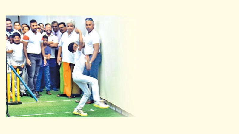 Arjuna Ranatunga and Chaminda Vaas watch a young bowler at the nets