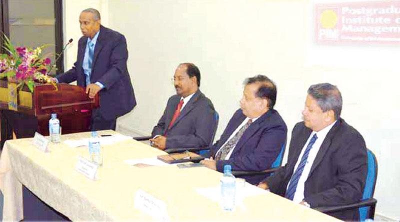 Prof. Sisira Jayakody addresses a research session at PIM. Dr. Trevor Mendis (left), Prof. P.S.M. Gunarathne and Prof. Ajantha Dharmasiri at the head table - File pic